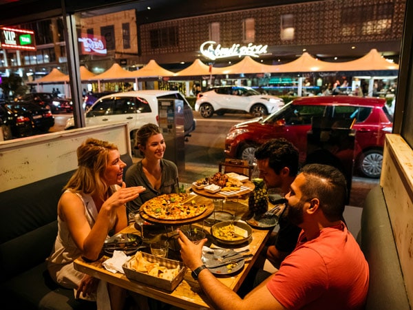 friends enjoying pizza at Mama and Papas along Eat Street, Parramatta