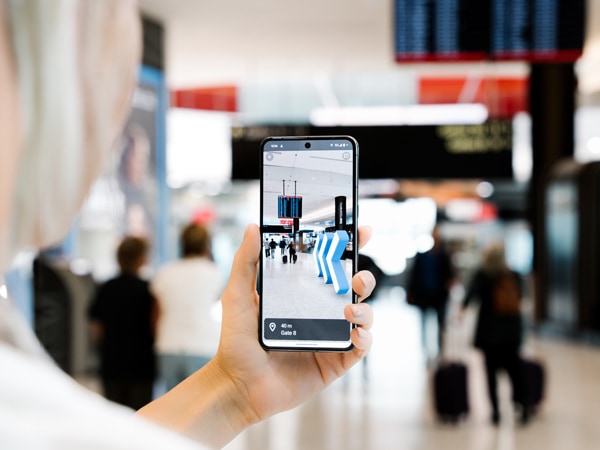 Google Maps Indoor Live View phone with arrows directing to gate at Sydney Airport