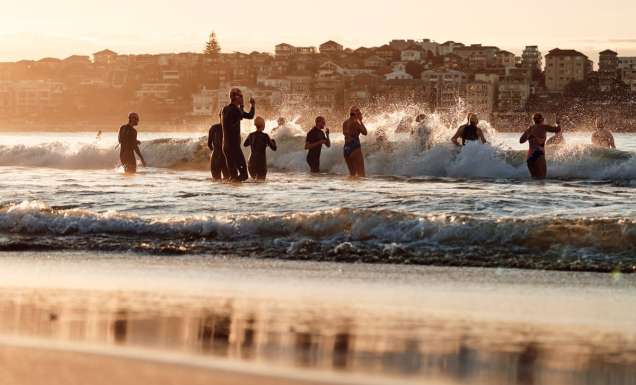 Locals run into the water at Bondi Beach