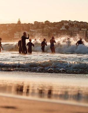 Locals run into the water at Bondi Beach