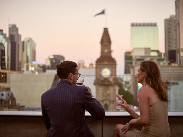 a couple enjoying drinks on top of The Stolen Gem, Melbourne CBD