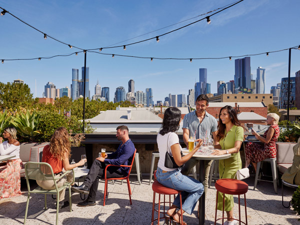 people drinking at Johnny’s Green Room rooftop bar in Carlton
