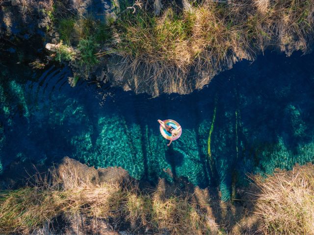 A woman floating on a donut in Bitter Springs, Elsey National Park, NT