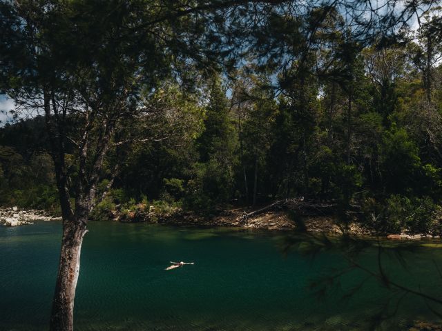 A woman swimming in Apsley River Waterhole