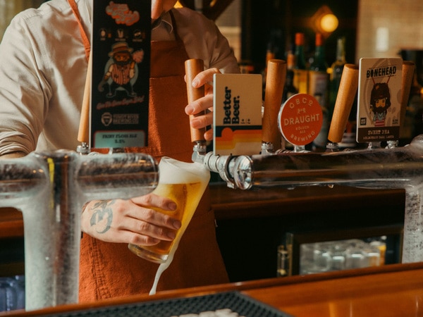 pouring some tap beer into the glass at Amphlett House