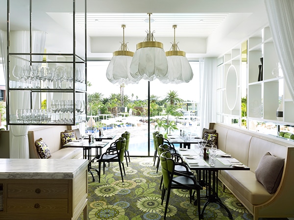 Leafy light and bright restaurant Bistro Guillaume in Perth with hanging greenery.