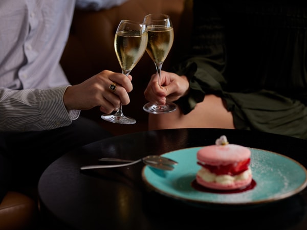 clinking glasses of champagne at Bistro Guillaume