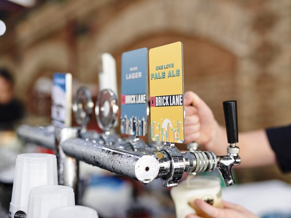 pouring a tap beer into a glass at Brick Lane Brewing
