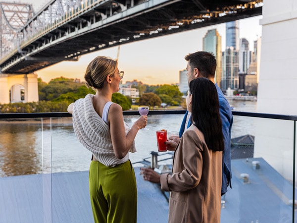 enjoying drinks on the rooftop of Crystalbrook Vincent overlooking the Brisbane River and Story Bridge