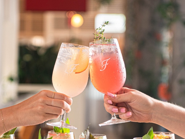 clinking cocktail glasses at Fratelli Fresh