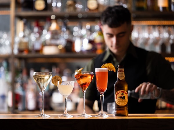 a bartender preparing drinks at Jackalberry Bar