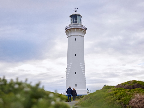 a couple walking around the Green Cape Lighthouse, Green Cape