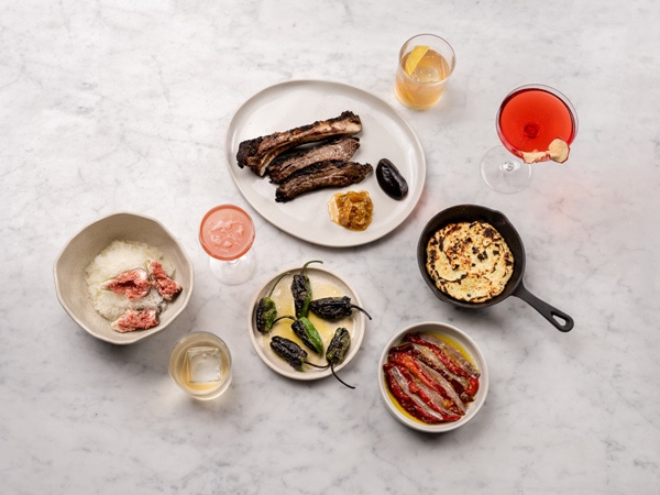 a table-top view of food and drinks at NOMAD Melbourne