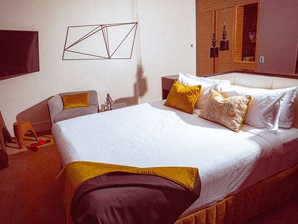 A quirky room in tones of turmeric and paprika at QT Sydney.