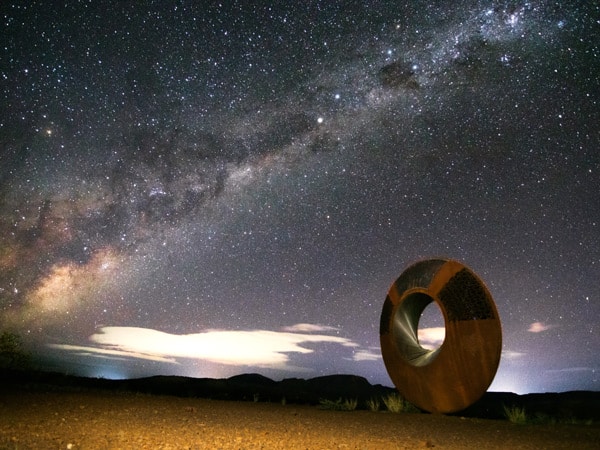 the Resilience art sculpture under the Milky Way