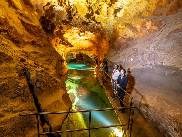 a group passing through the River Cave system atJenolan Caves in the Blue Mountains