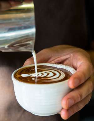pouring milk over coffee at Industry Beans, Fitzroy