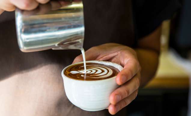 pouring milk over coffee at Industry Beans, Fitzroy
