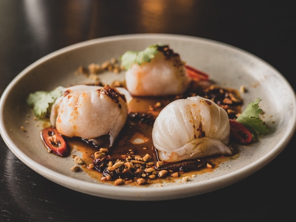 a plate of braised pork bao, HQ Bar + Kitchen