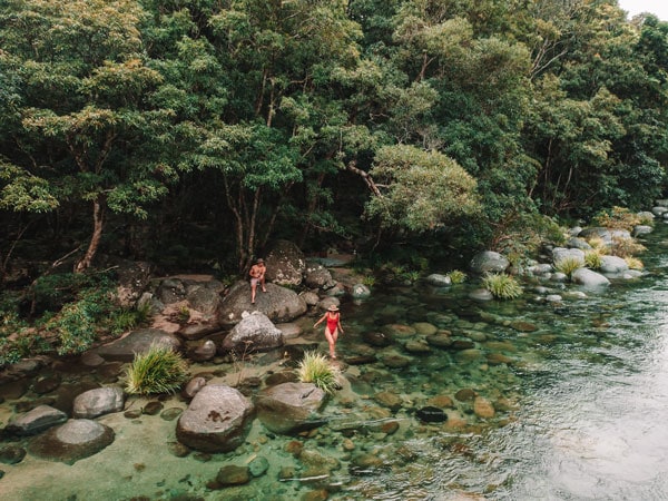 a couple cooling off at the pristine Mossman River in the Daintree Rainforest
