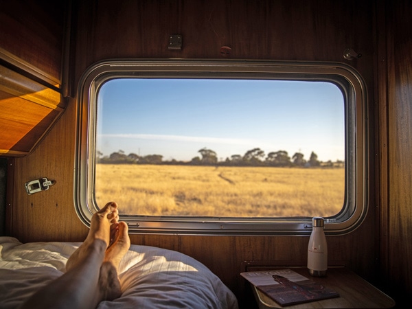 feet relaxing by the window of a train, The Great Southern