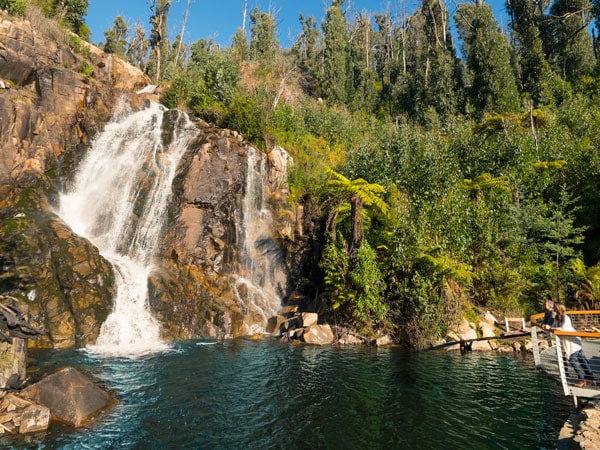 two people on the side looking up at the Steavenson Falls, Marysville
