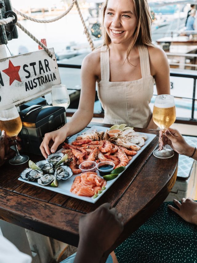 a woman enjoying local seafood at Prawn Star, Mooloolaba