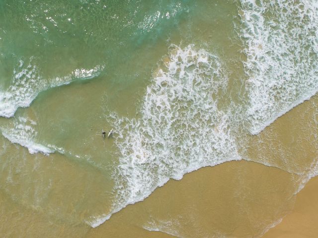 surfing at Mooloolaba Spit Beach
