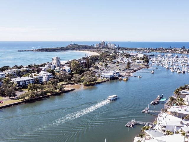 a boat whisking past the wharf, Sunreef Mooloolaba