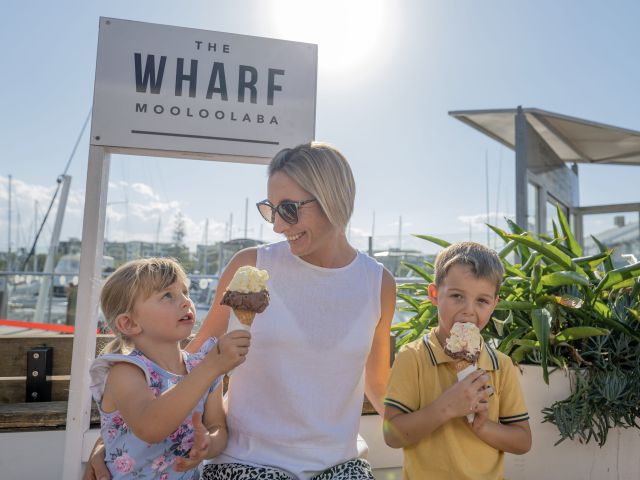 a mother with her two kids enjoying ice cream at The Wharf Mooloolaba