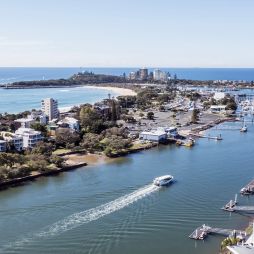 a boat whisking past the wharf, Sunreef Mooloolaba