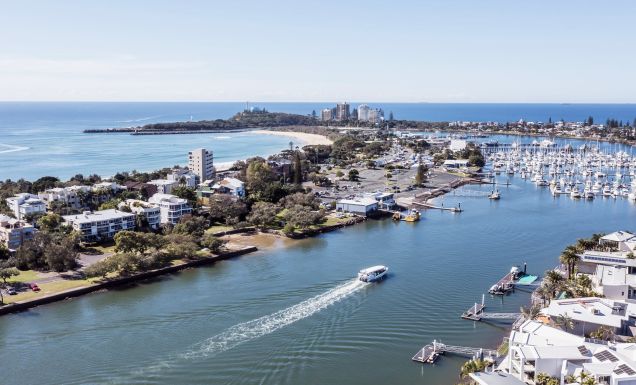 a boat whisking past the wharf, Sunreef Mooloolaba