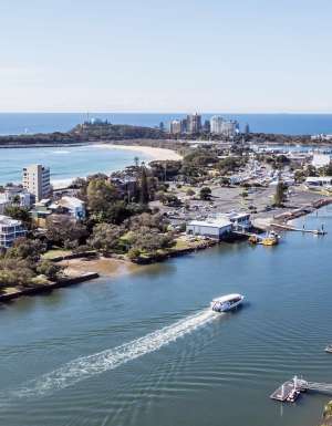 a boat whisking past the wharf, Sunreef Mooloolaba