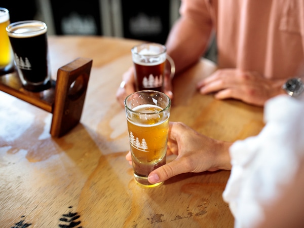 two people enjoying beers at the 4 Pines Brewing Co. TruckBar, Brookvale