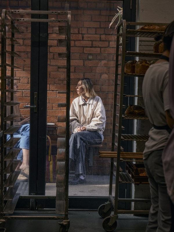 Woman sitting outside All Are Welcome in Melbourne