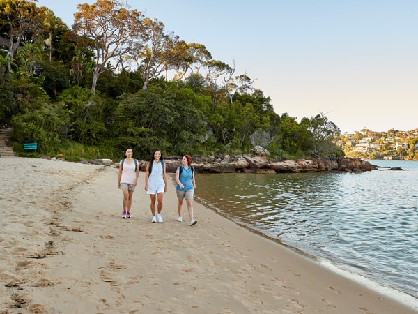 friends walking along Clontarf Beach