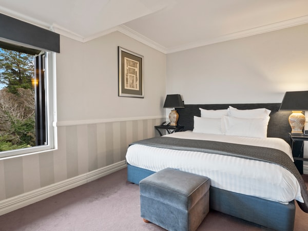 the corner view suite bedroom with a window