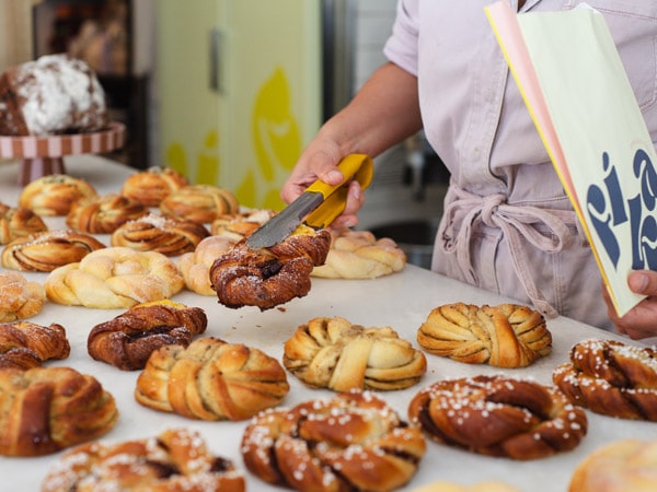 Cafe worker selects Fika Swedish pastries