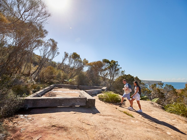 friends visiting the Grotto Point Aboriginal engravingsalong the Spit Bridge to Manly walk