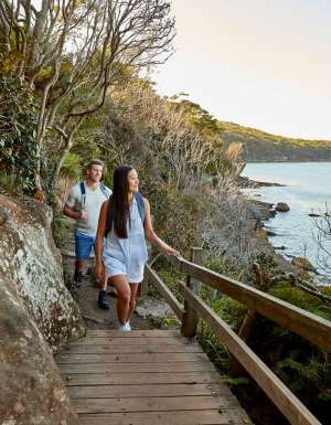 a couple enjoying the walk from Spit Bridge to Manly with scenic views across Sydney Harbour