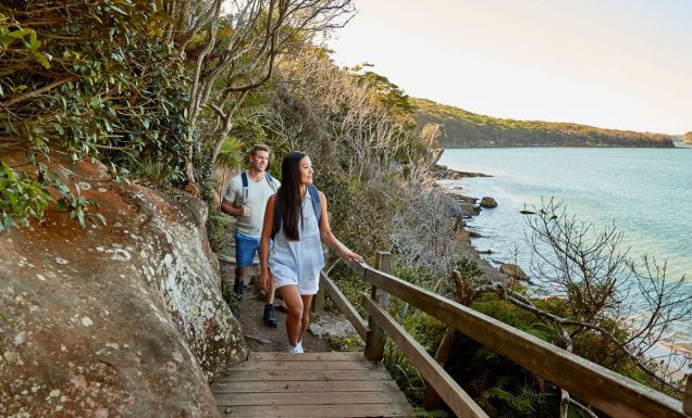 a couple enjoying the walk from Spit Bridge to Manly with scenic views across Sydney Harbour