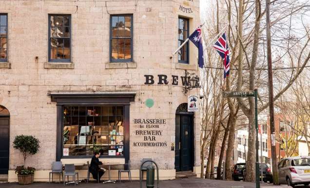A patron sits out front of the Lord Nelson Pub in The Rocks.