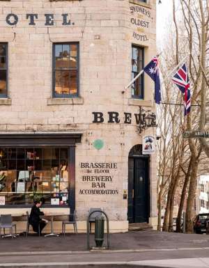 A patron sits out front of the Lord Nelson Pub in The Rocks.