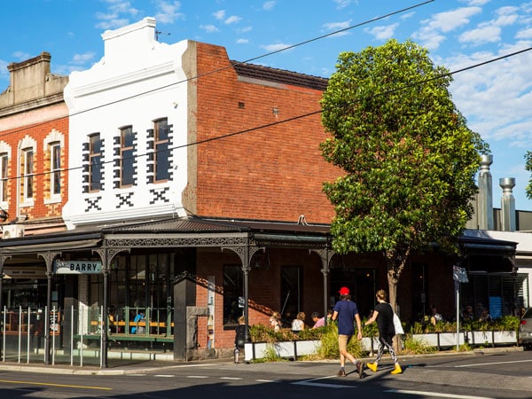 People cross the road on High Street, Northcote