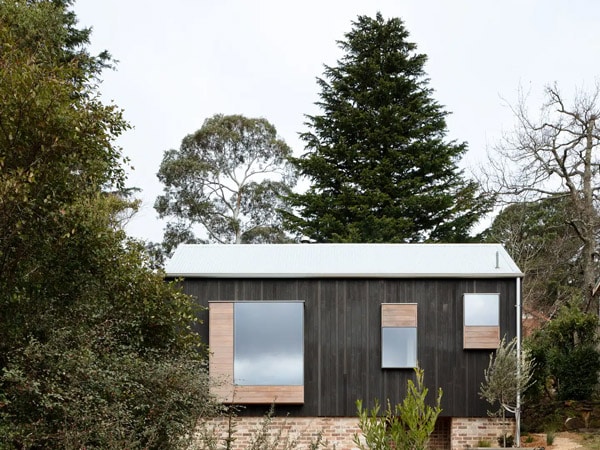 the Little Black Cabin surrounded by trees in Blackheath