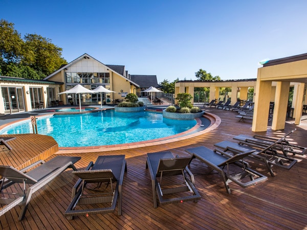 an outdoor pool with sun loungers at Fairmont Resort in Leura