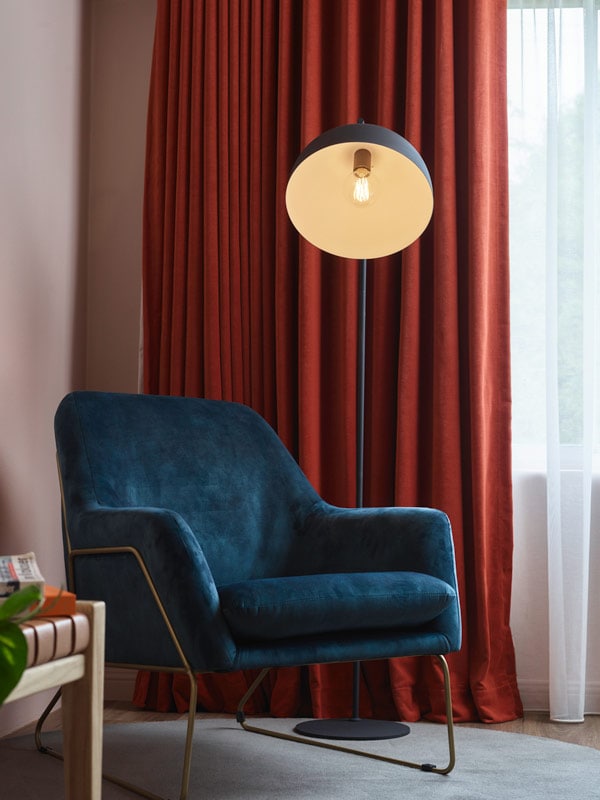 Room details feature a chair and lamp