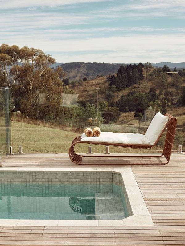the pool with a sun lounger and scenic views in the background at The Lodge, Blackheath