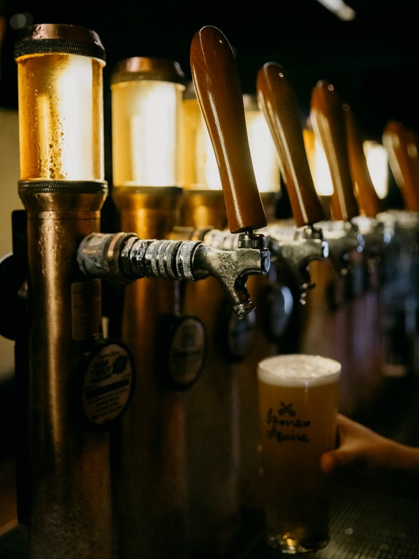 pouring beer into a glass at The Squires Landing, Sydney