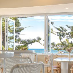 inside Dune by Pavilion with wide windows overlooking the beach